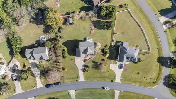 an aerial view of residential houses with outdoor space and swimming pool