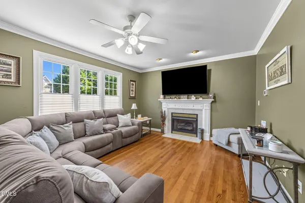 a living room with furniture and a wooden floor