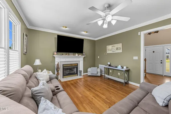 a dining room with furniture a chandelier and wooden floor
