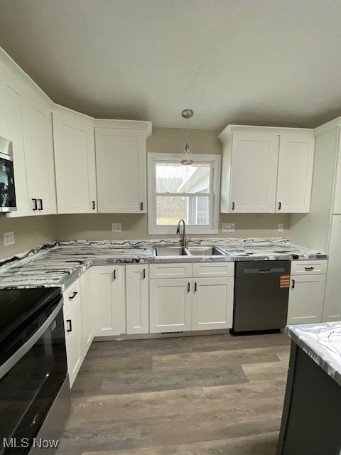 2868 Pressler Road Uniontown, OH 44685 - Photo 12 of 37 Kitchen with dishwashing machine, light wood finished floors, a sink, white cabinets, and range