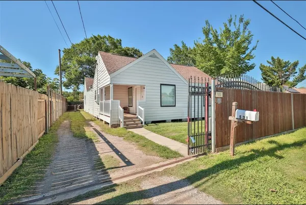 a view of a house with a backyard