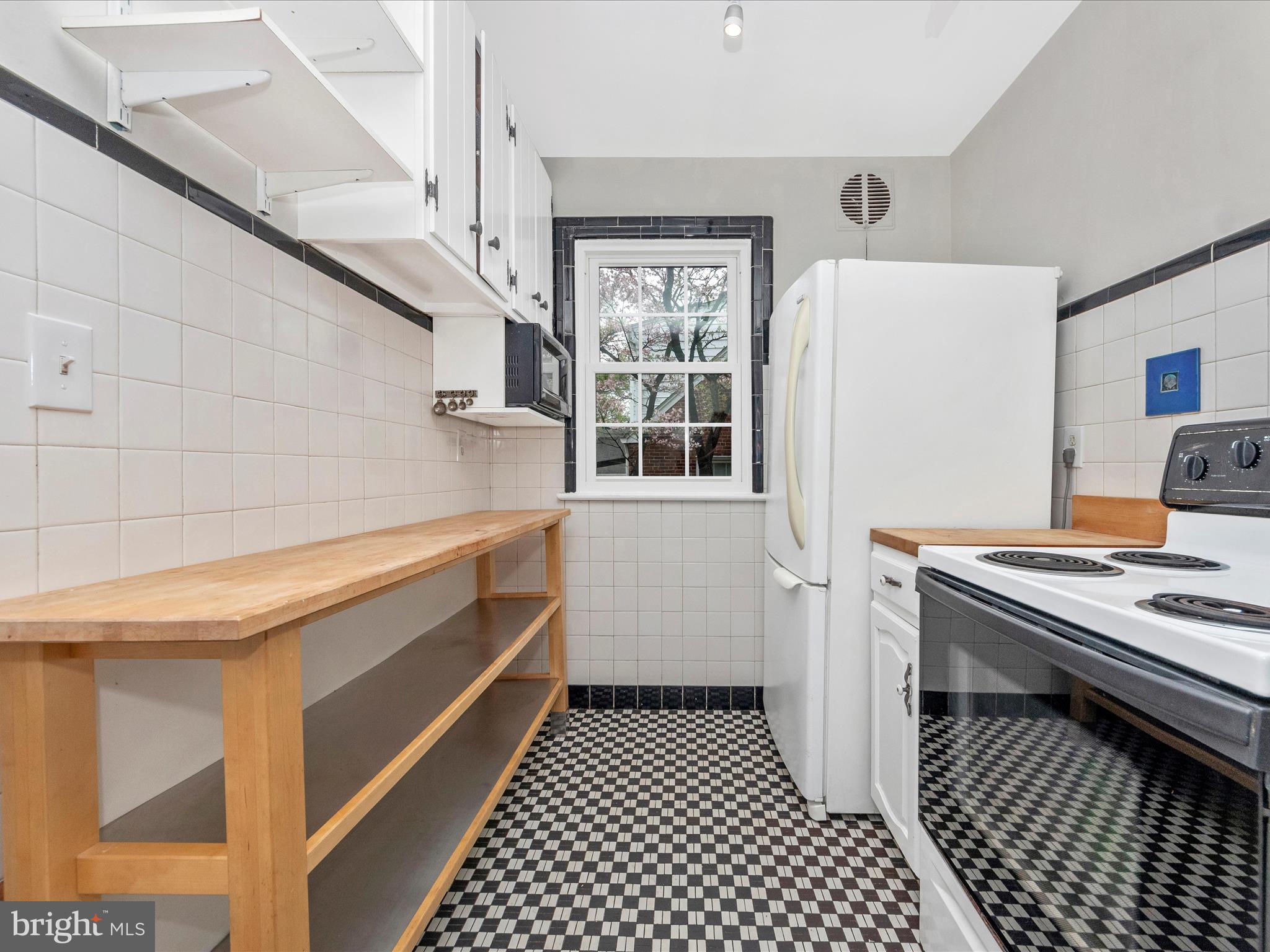 9905 Portland Road Silver Spring, MD 20901 - Photo 13 of 52 a kitchen with a sink and a stove top oven