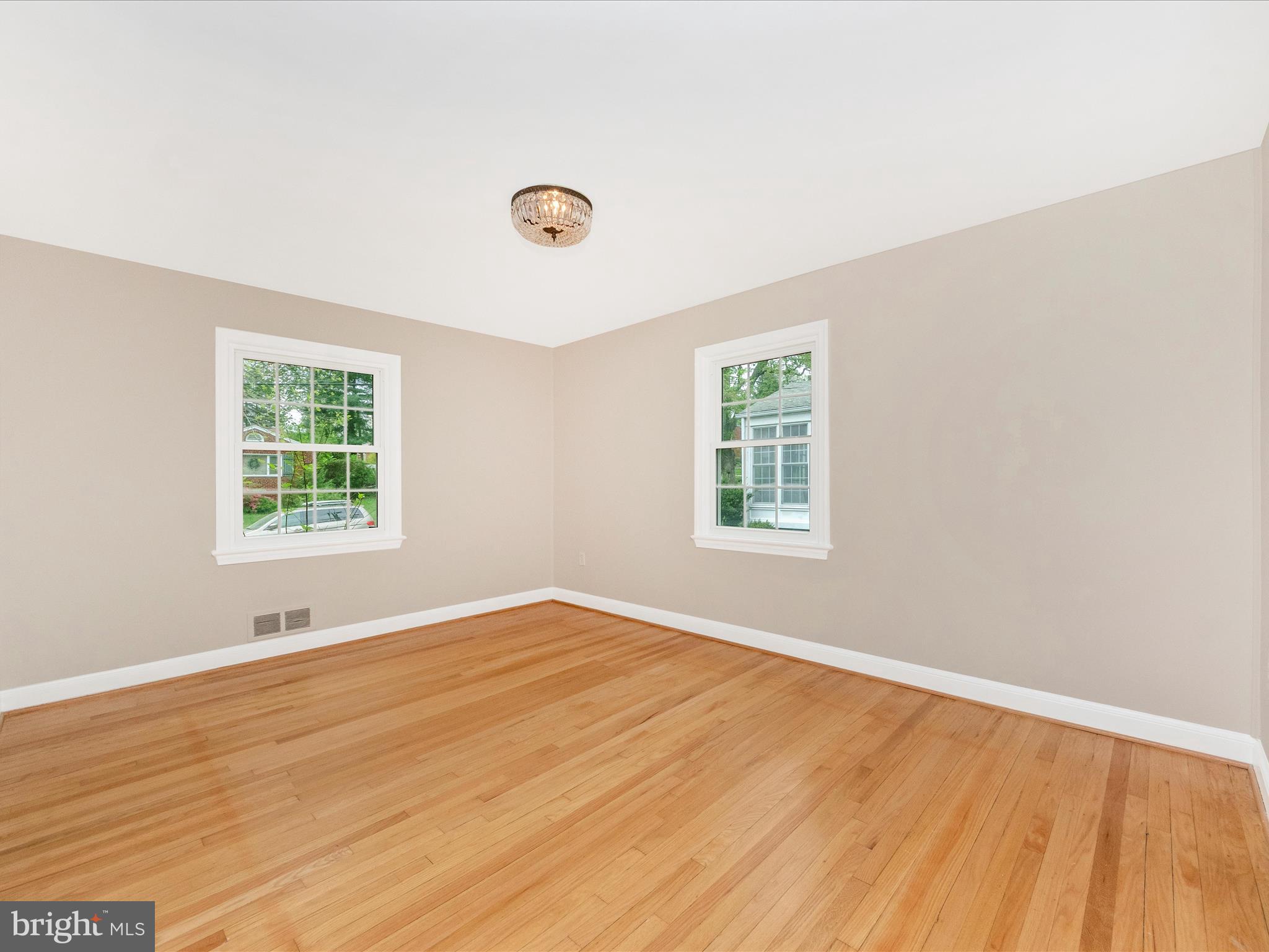 9905 Portland Road Silver Spring, MD 20901 - Photo 17 of 52 an empty room with wooden floor and windows