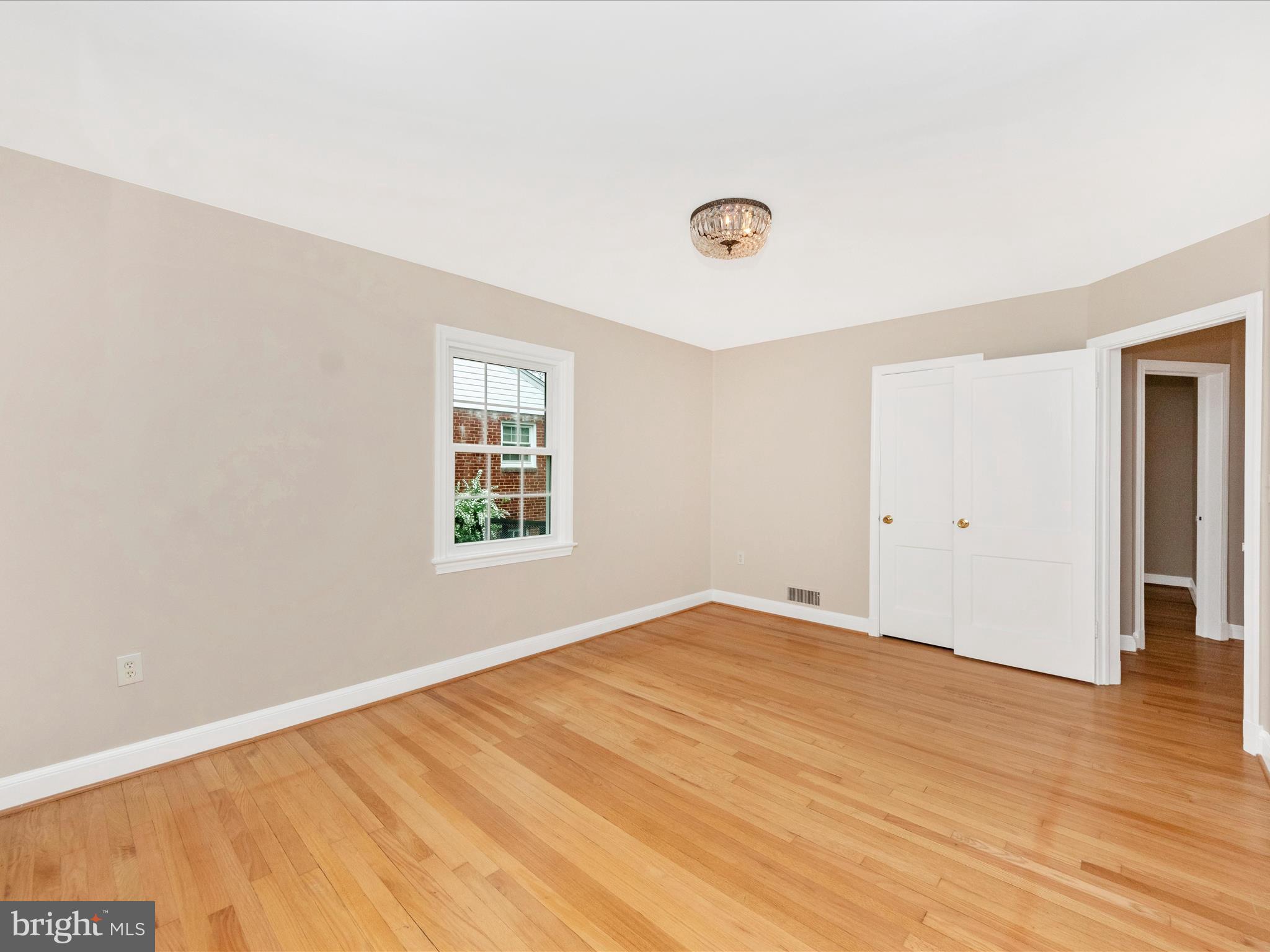 9905 Portland Road Silver Spring, MD 20901 - Photo 18 of 52 a view of an empty room with wooden floor and a window
