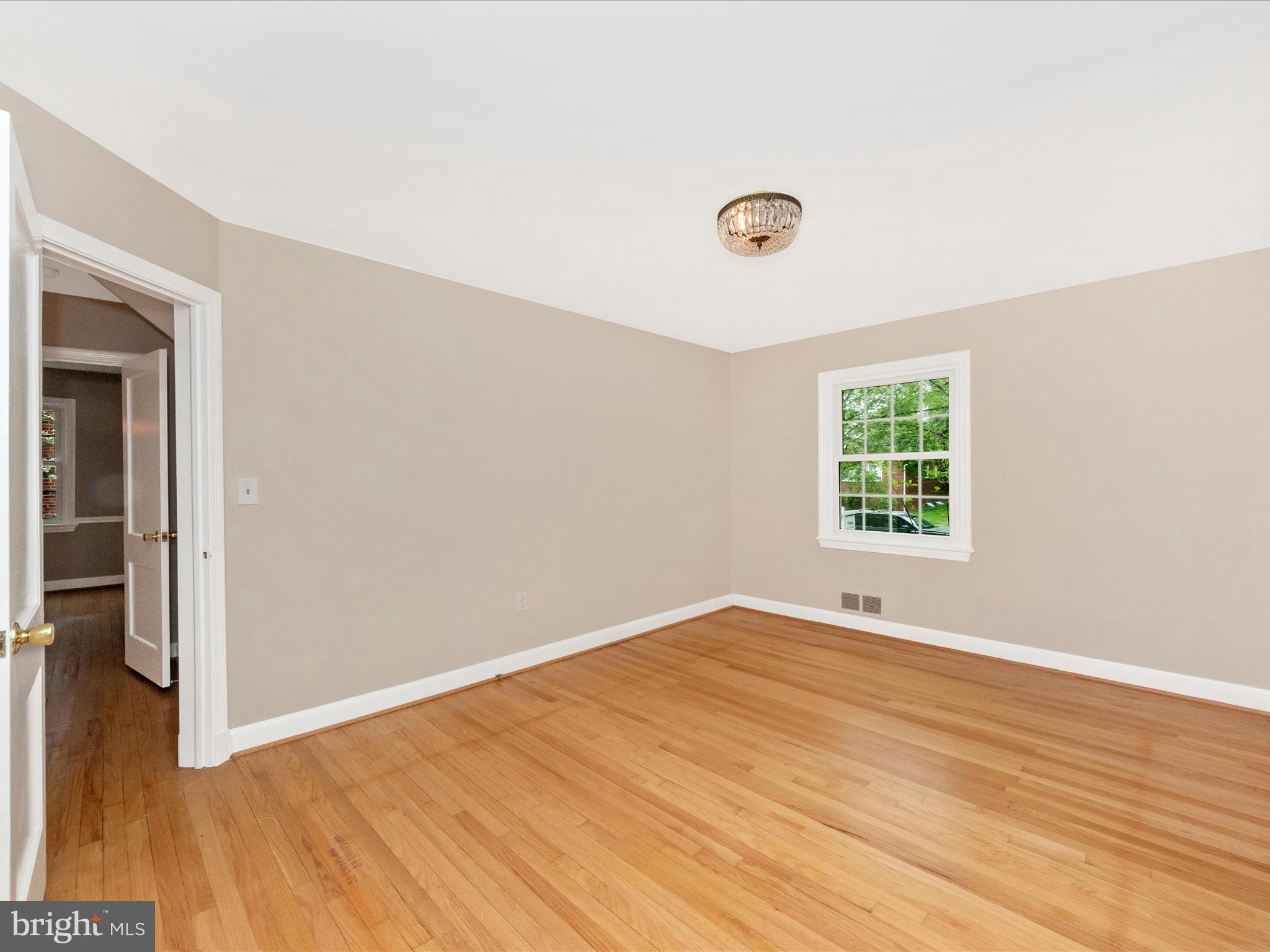 9905 Portland Road Silver Spring, MD 20901 - Photo 20 of 52 an empty room with wooden floor and windows