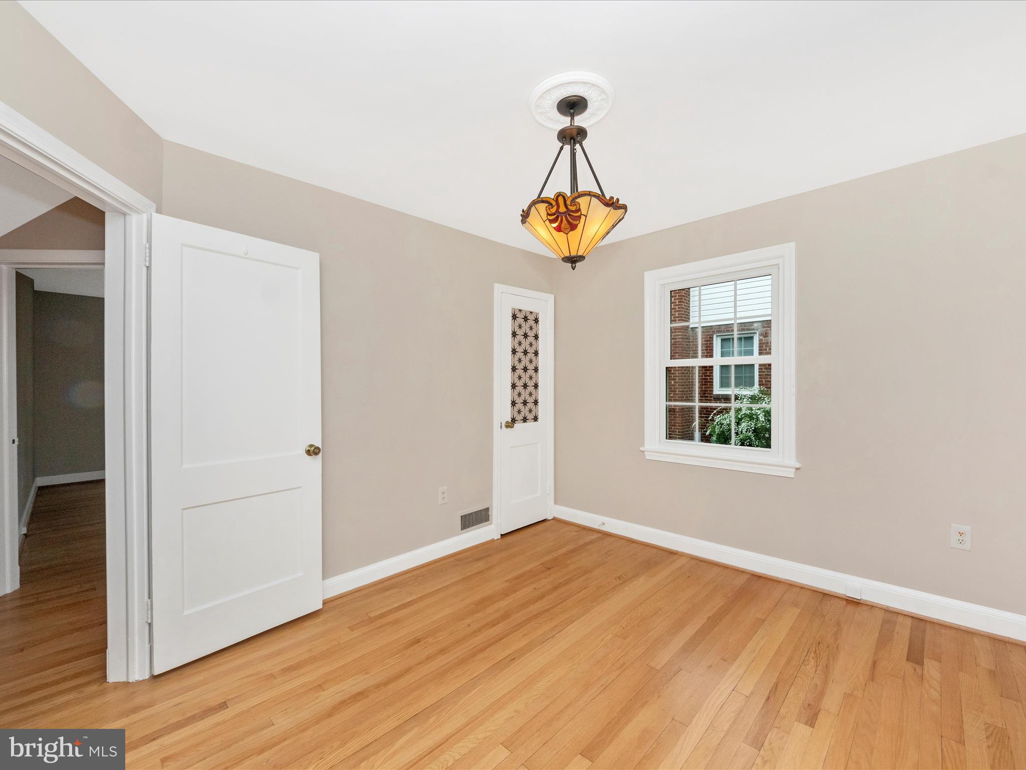 9905 Portland Road Silver Spring, MD 20901 - Photo 25 of 52 an empty room with wooden floor and windows