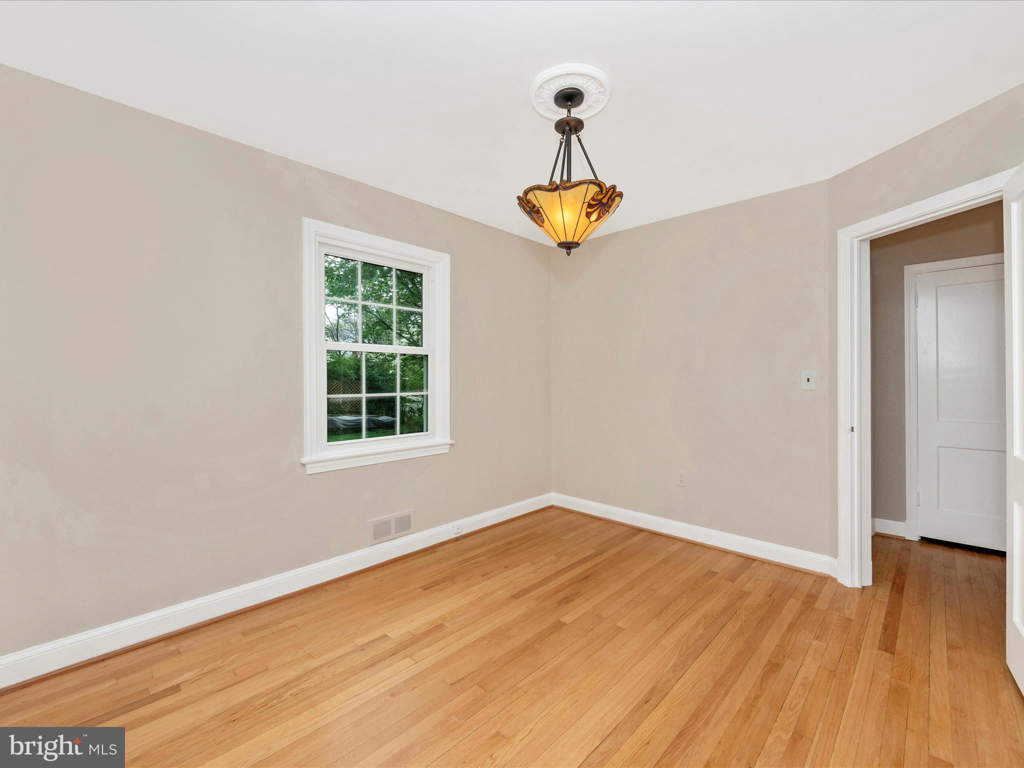 9905 Portland Road Silver Spring, MD 20901 - Photo 26 of 52 a view of empty room with wooden floor and chandelier