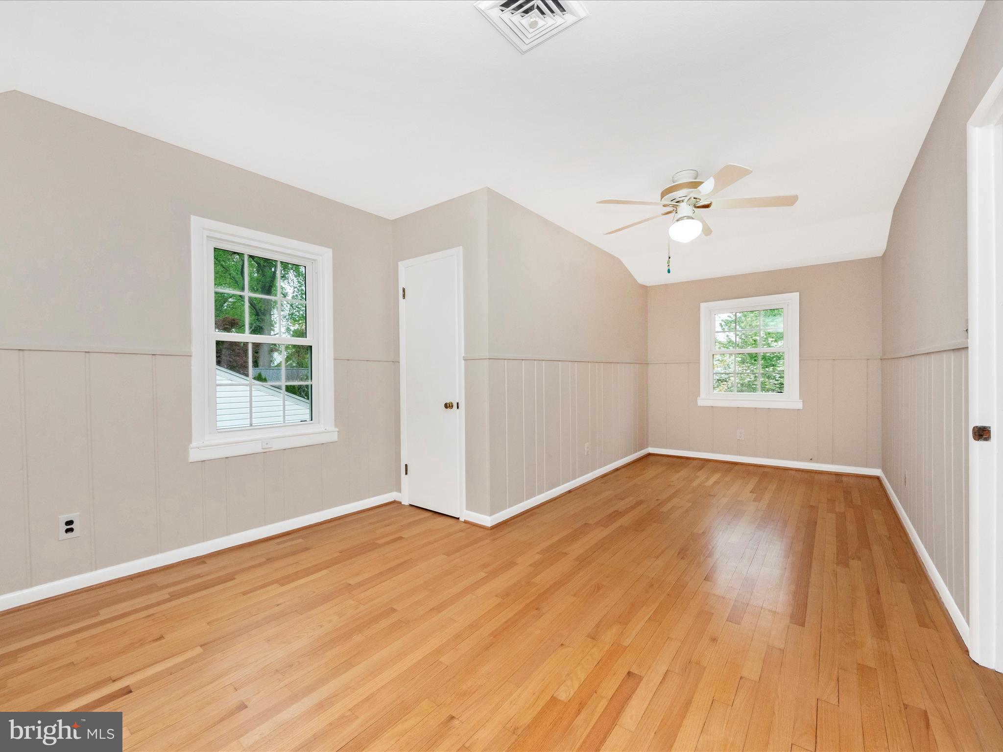 9905 Portland Road Silver Spring, MD 20901 - Photo 28 of 52 an empty room with windows and ceiling fan