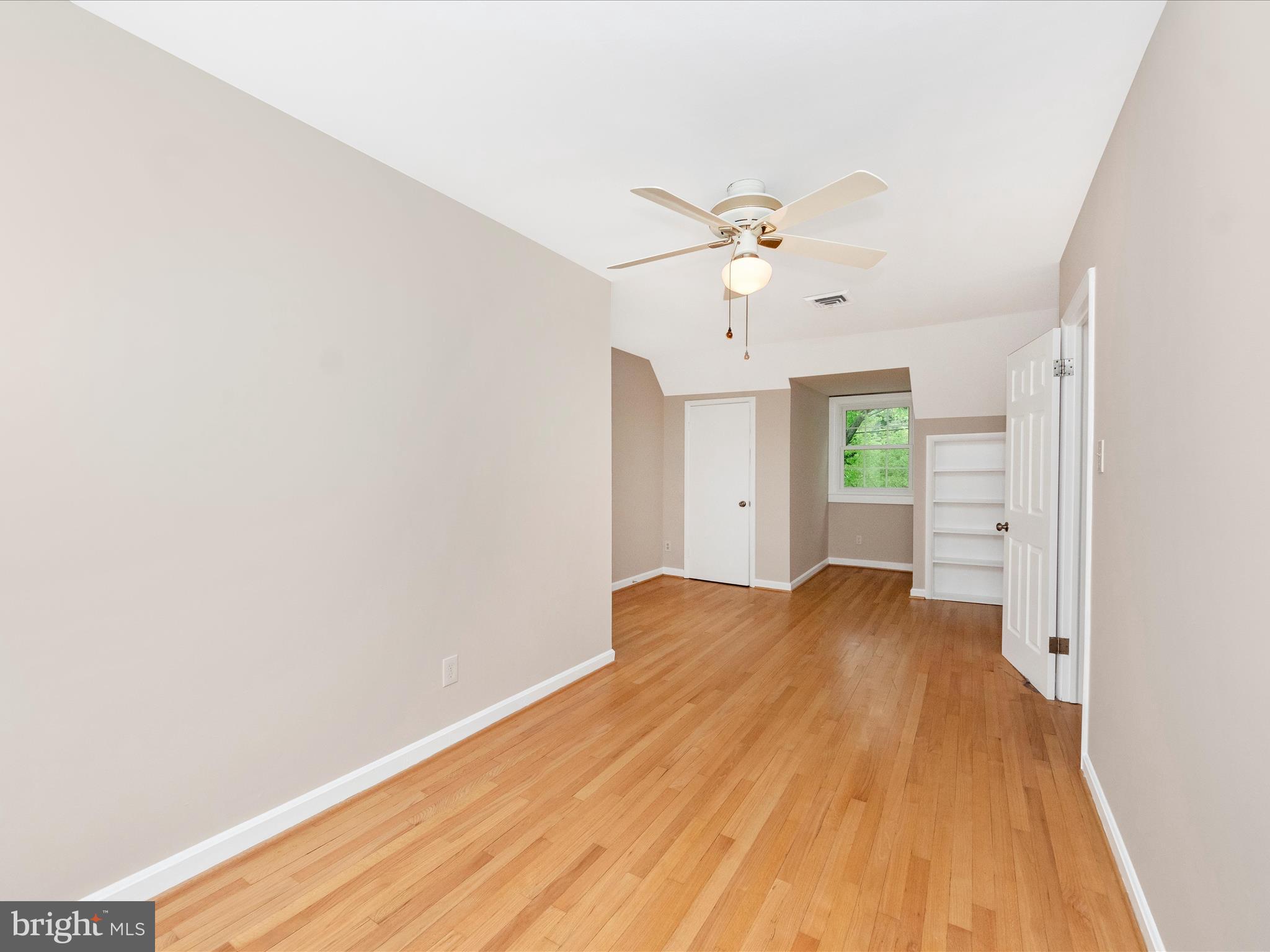 9905 Portland Road Silver Spring, MD 20901 - Photo 31 of 52 a view of a bedroom with wooden floor and a ceiling fan