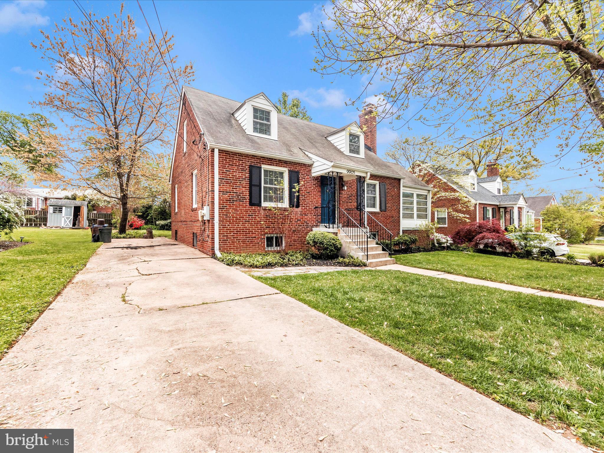 9905 Portland Road Silver Spring, MD 20901 - Photo 45 of 52 a front view of a house with a yard and potted plants