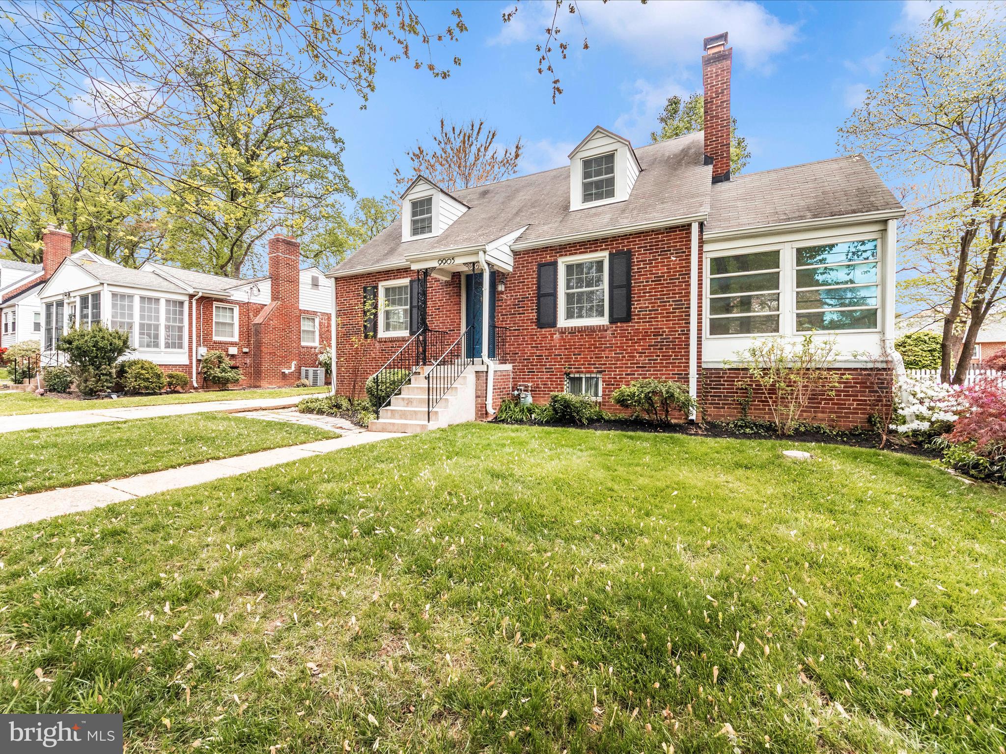 9905 Portland Road Silver Spring, MD 20901 - Photo 47 of 52 a front view of a house with a yard and outdoor seating