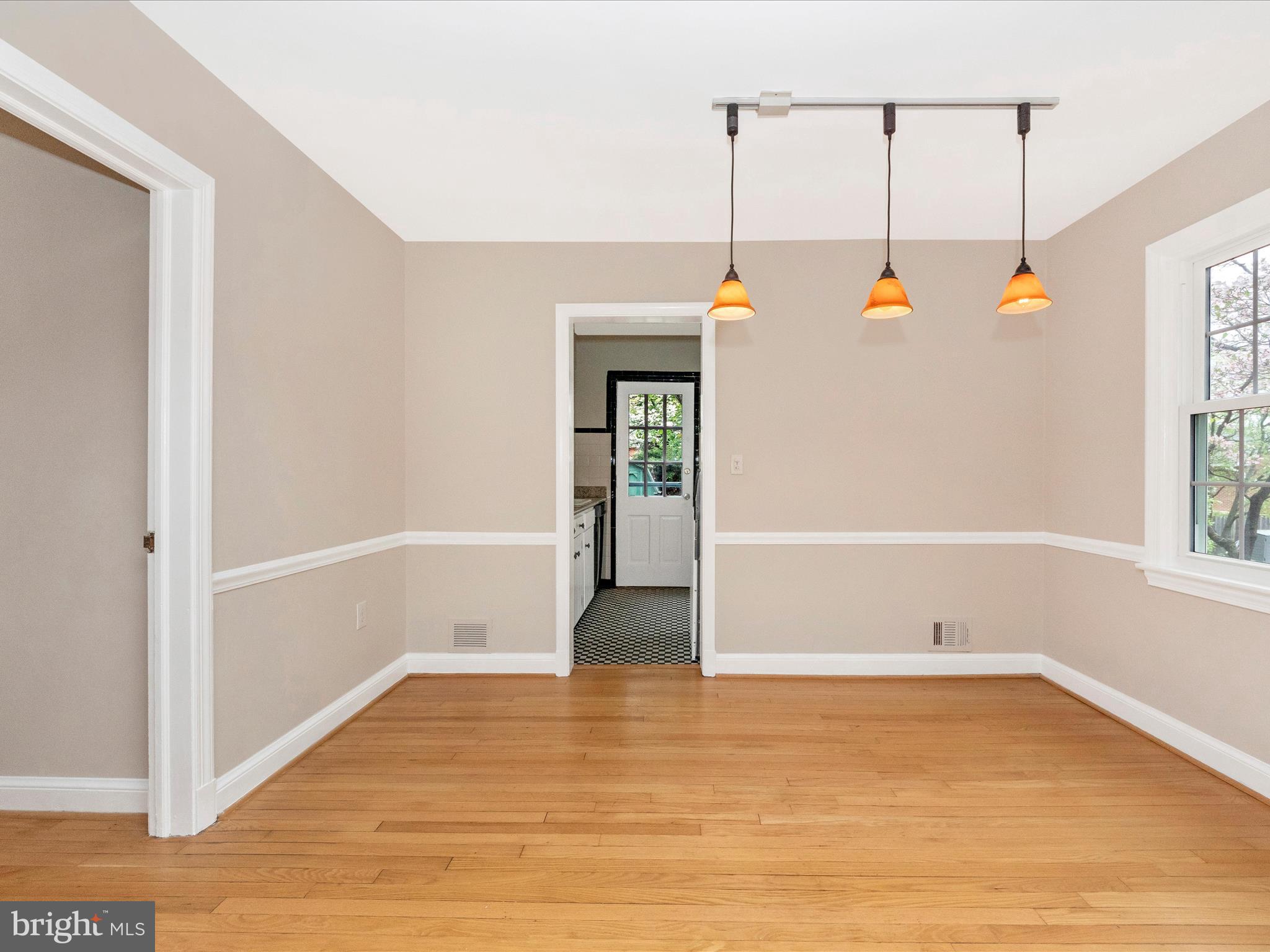 9905 Portland Road Silver Spring, MD 20901 - Photo 8 of 52 a view of an empty room with wooden floor and windows