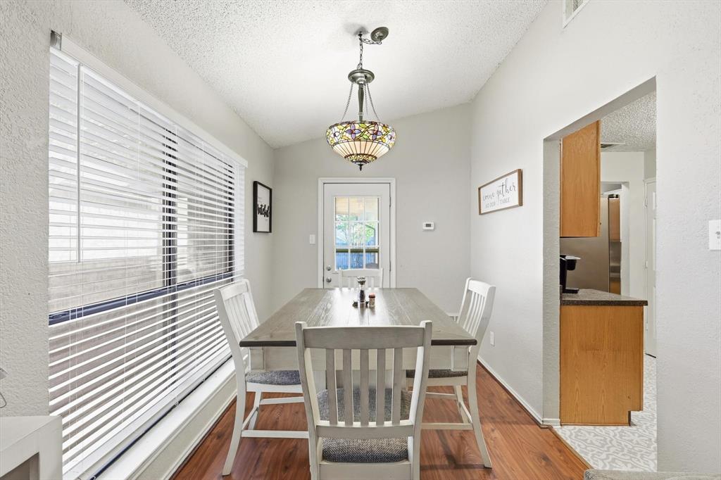 1312 Hackamore Street Mesquite, TX 75149 - Photo 6 of 23 Dining area featuring a textured ceiling, dark wood-style floors, and a textured wall