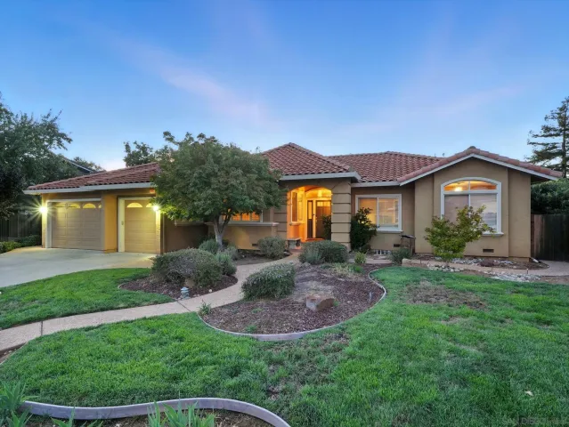 a view of a house with a backyard