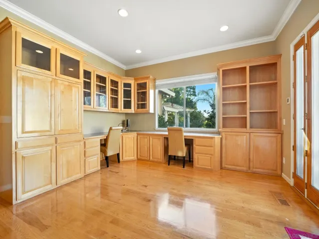 a view of work space with furniture and windows
