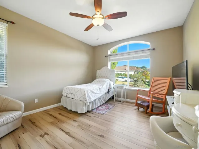 a bedroom with a bed and a large window