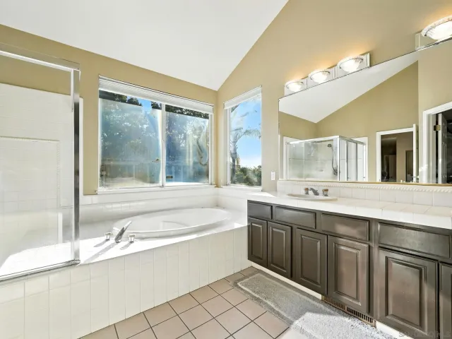 a large bathroom with a large tub and sink