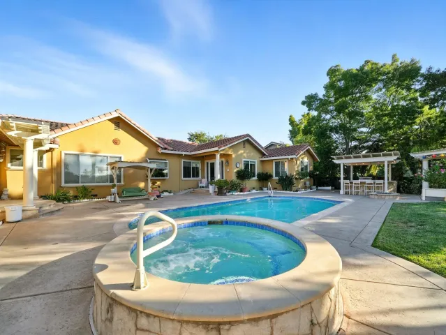 a swimming pool with outdoor seating and yard