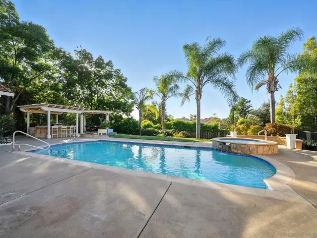 a view of a swimming pool with a lounge chair