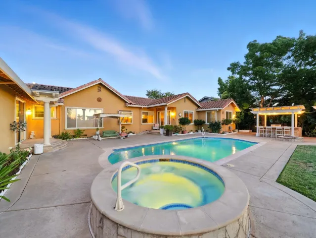a view of house with outdoor space and swimming pool