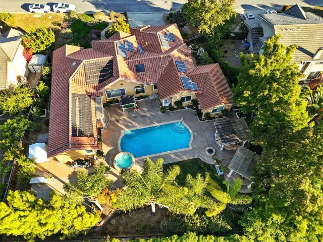 an aerial view of residential house with swimming pool
