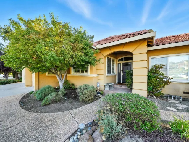 a front view of a house with garden