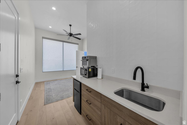 404 North Marsala Way St. George, UT 84770 - Photo 13 of 26 Kitchen with light wood-style floors, freestanding refrigerator, recessed lighting, modern cabinets, and ceiling fan