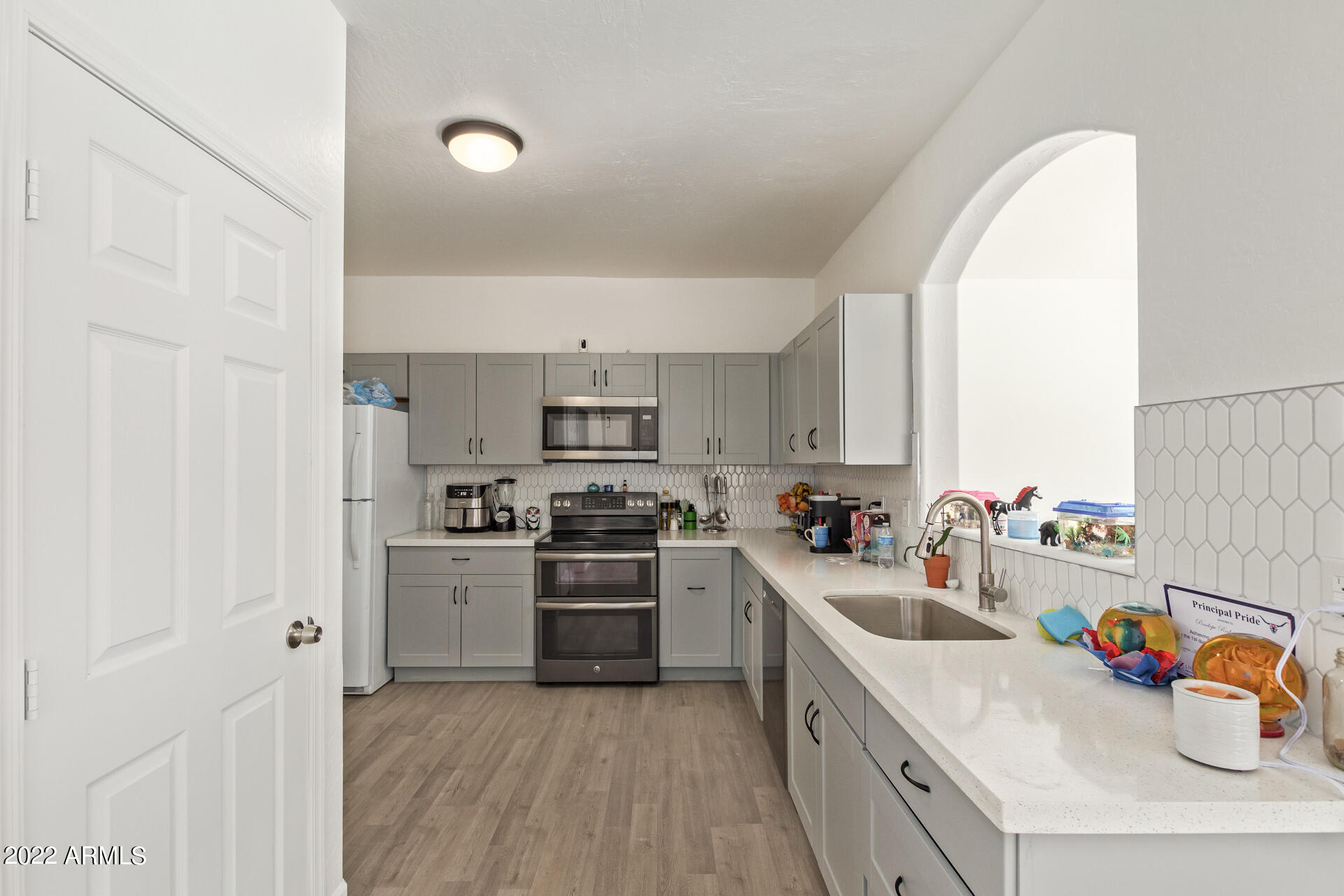 1315 West Fremont Rd. Phoenix, AZ 85041 - Photo 1 of 22 a kitchen with stainless steel appliances a sink dishwasher stove refrigerator and refrigerator