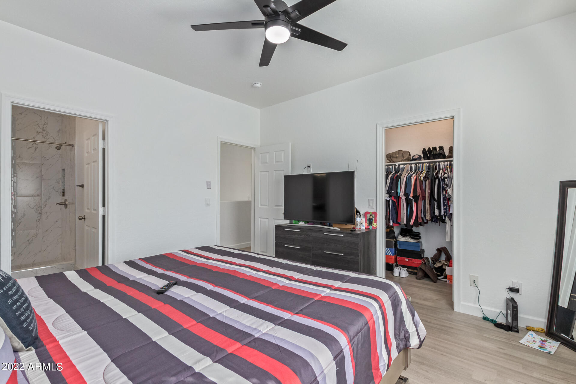 1315 West Fremont Rd. Phoenix, AZ 85041 - Photo 13 of 22 a bedroom with bed and a flat tv screen