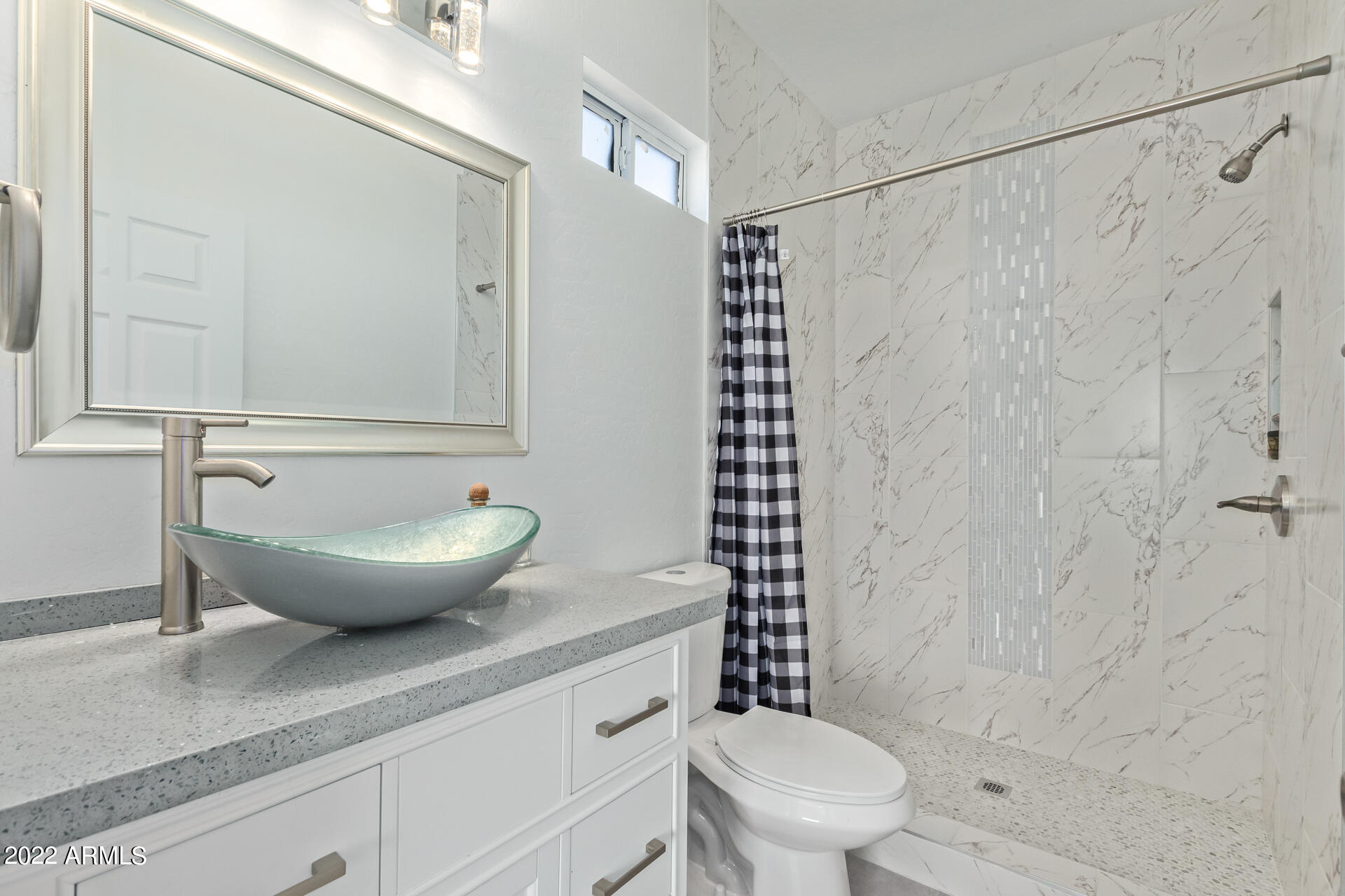1315 West Fremont Rd. Phoenix, AZ 85041 - Photo 14 of 22 a view of a bathroom with a granite countertop sink a toilet and shower