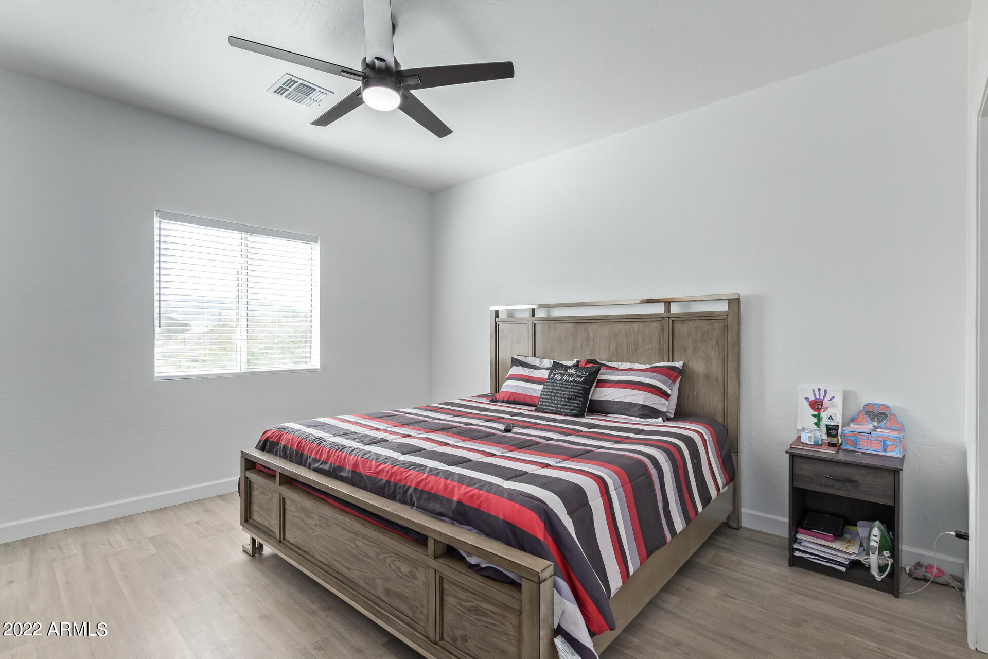1315 West Fremont Rd. Phoenix, AZ 85041 - Photo 10 of 22 a bedroom with a bed and a window