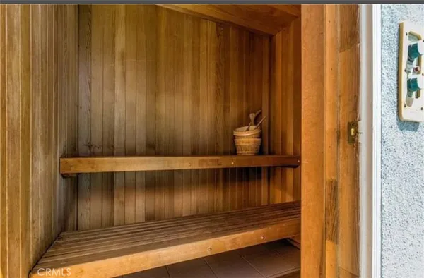 a bathroom with a sink and mirror with bathtub