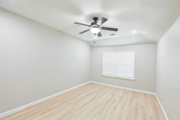 a view of an empty room and wooden floor
