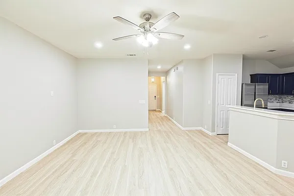 a view of kitchen with stainless steel appliances kitchen island a sink table and chairs