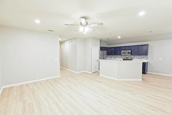 a view of a kitchen with a sink stainless steel appliances and cabinets