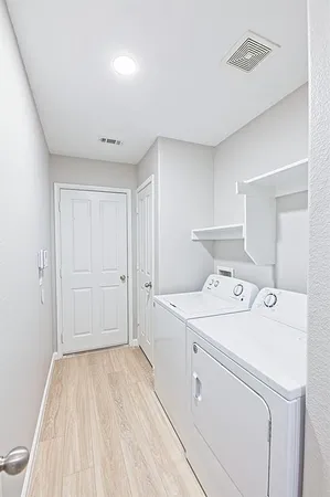 an empty room with a window and a ceiling fan