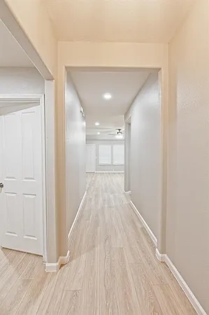 a view of a hallway with wooden floor