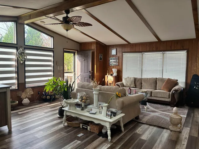 a living room with furniture and wooden floor