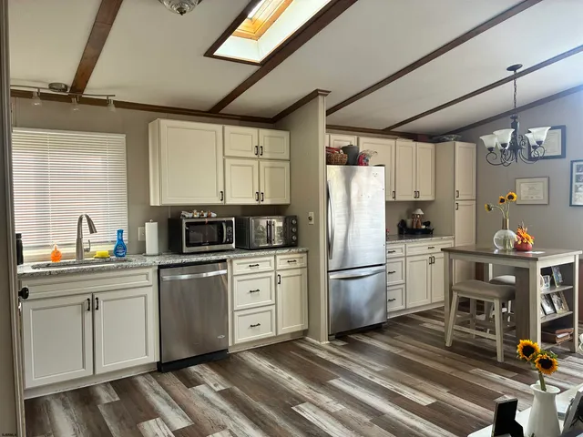 a kitchen with refrigerator cabinets and a sink
