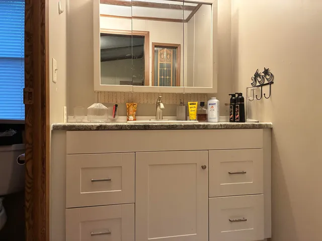 a bathroom with a sink and a mirror