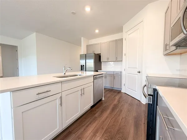 a kitchen with a sink window and cabinets