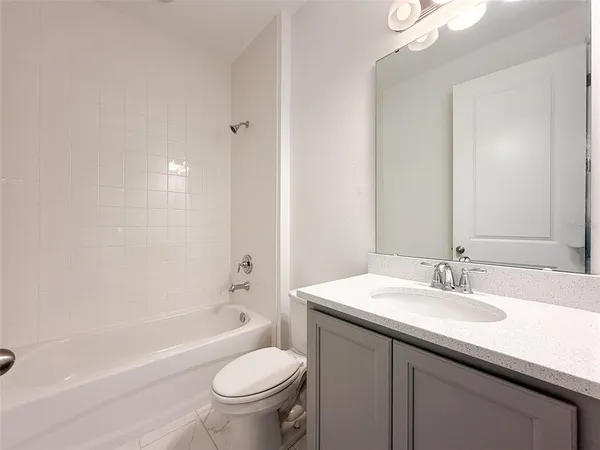 a bathroom with a sink a toilet and bathtub