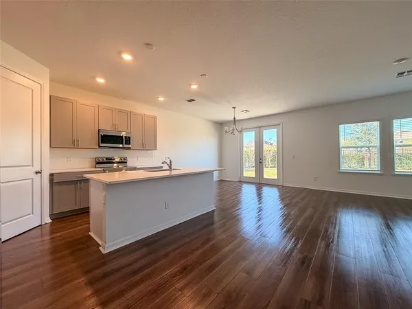 a kitchen with a refrigerator and a stove top oven