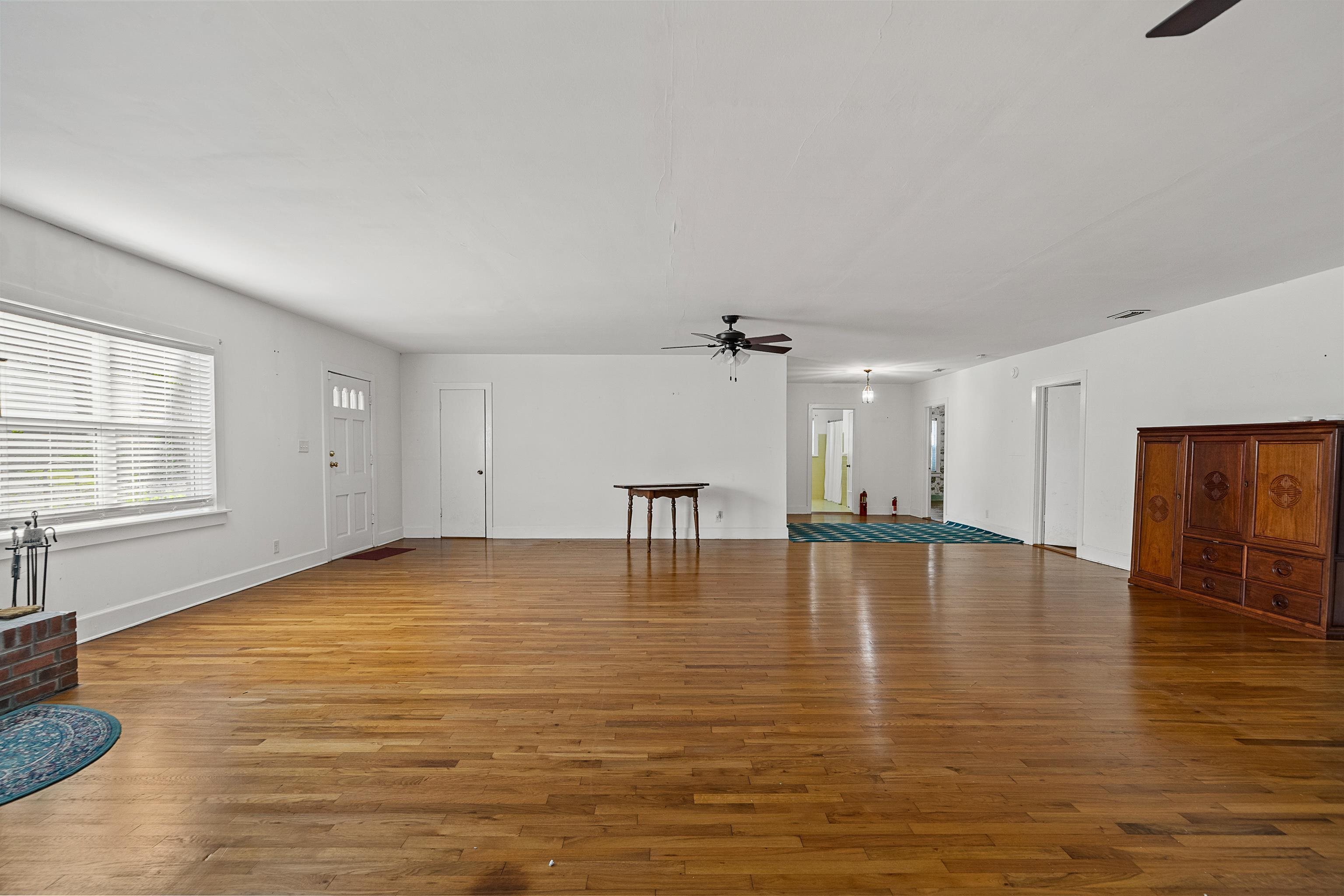 9350 Tompkins Road Stockton, AL 36579 - Photo 15 of 36 Unfurnished living room featuring a ceiling fan and light wood-style flooring