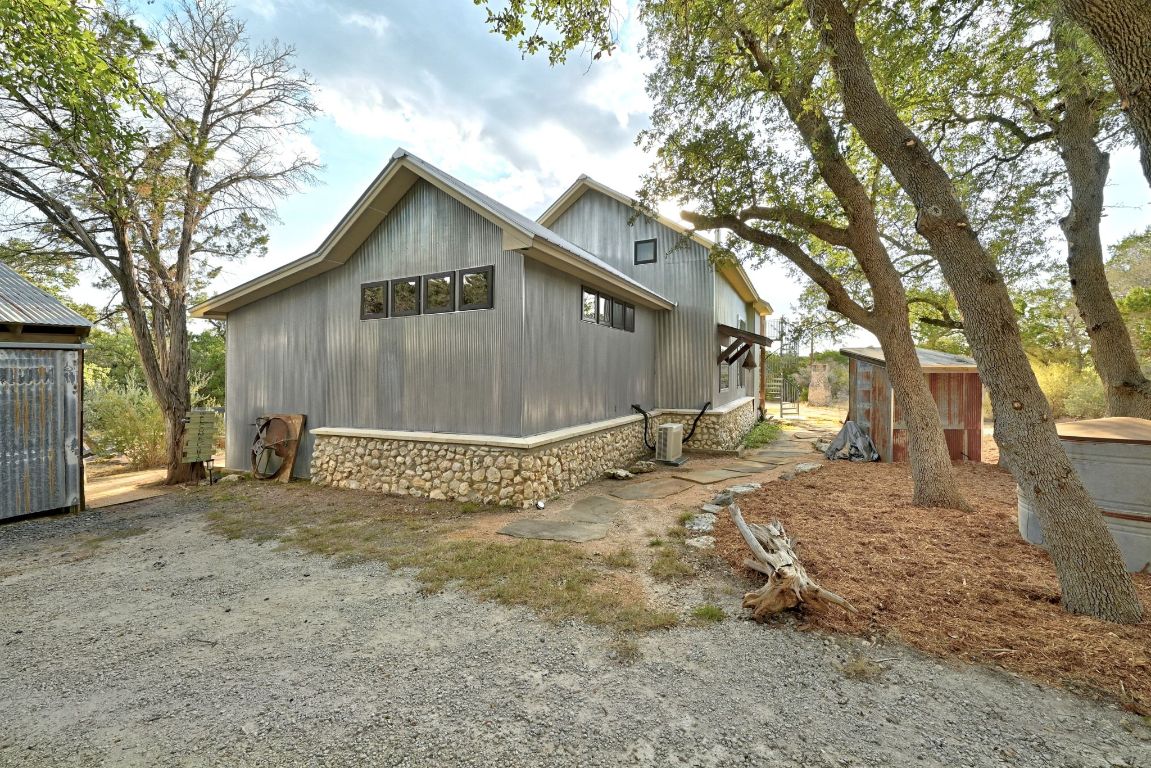 1910 Sandy Point Road Wimberley, TX 78676 - Photo 12 of 40 a view of a house with a yard covered in snow