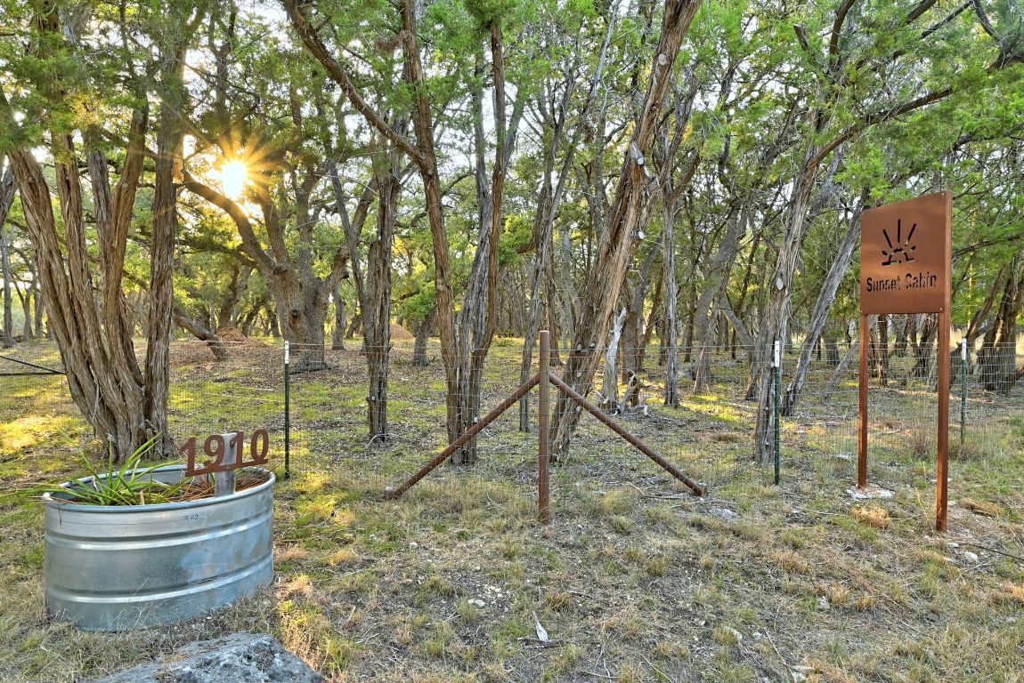 1910 Sandy Point Road Wimberley, TX 78676 - Photo 13 of 40 a view of a house with a yard and sitting area
