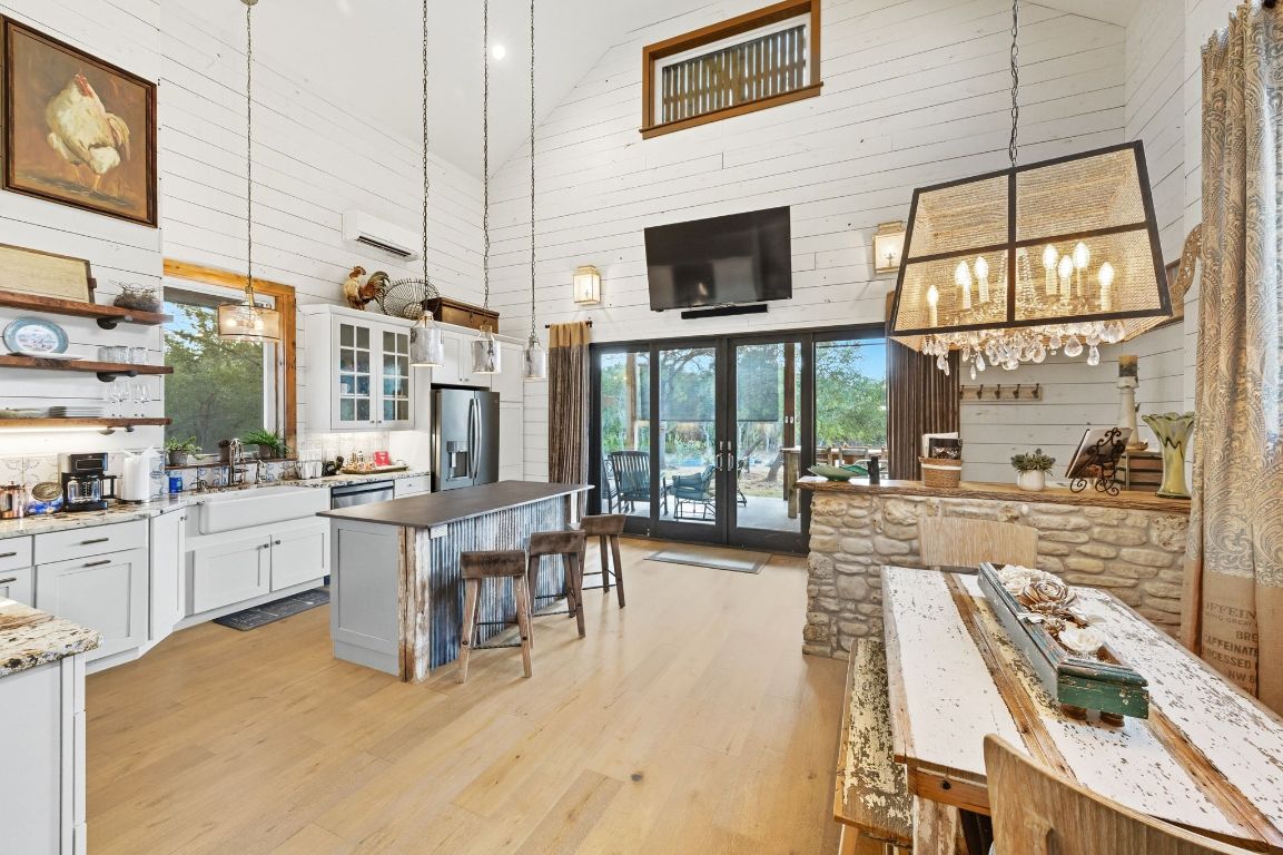 1910 Sandy Point Road Wimberley, TX 78676 - Photo 14 of 40 a large white kitchen with a large window