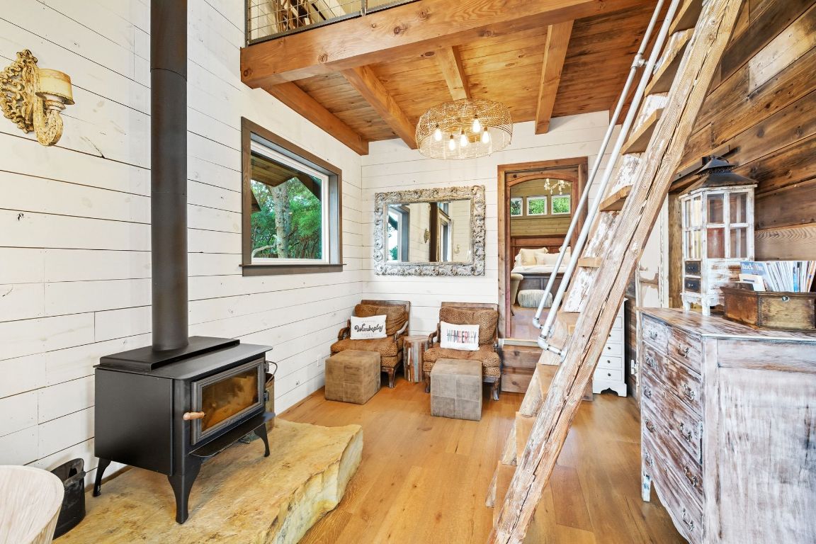 1910 Sandy Point Road Wimberley, TX 78676 - Photo 17 of 40 a view of a patio with couches chairs and kitchen view