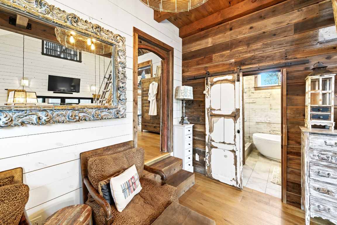 1910 Sandy Point Road Wimberley, TX 78676 - Photo 18 of 40 a living room with furniture a flat screen tv and a table