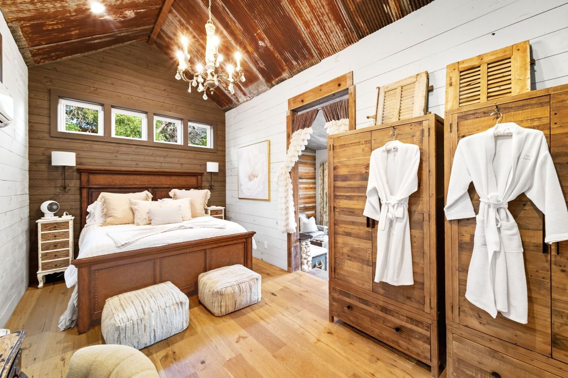 1910 Sandy Point Road Wimberley, TX 78676 - Photo 23 of 40 a living room with furniture and a chandelier
